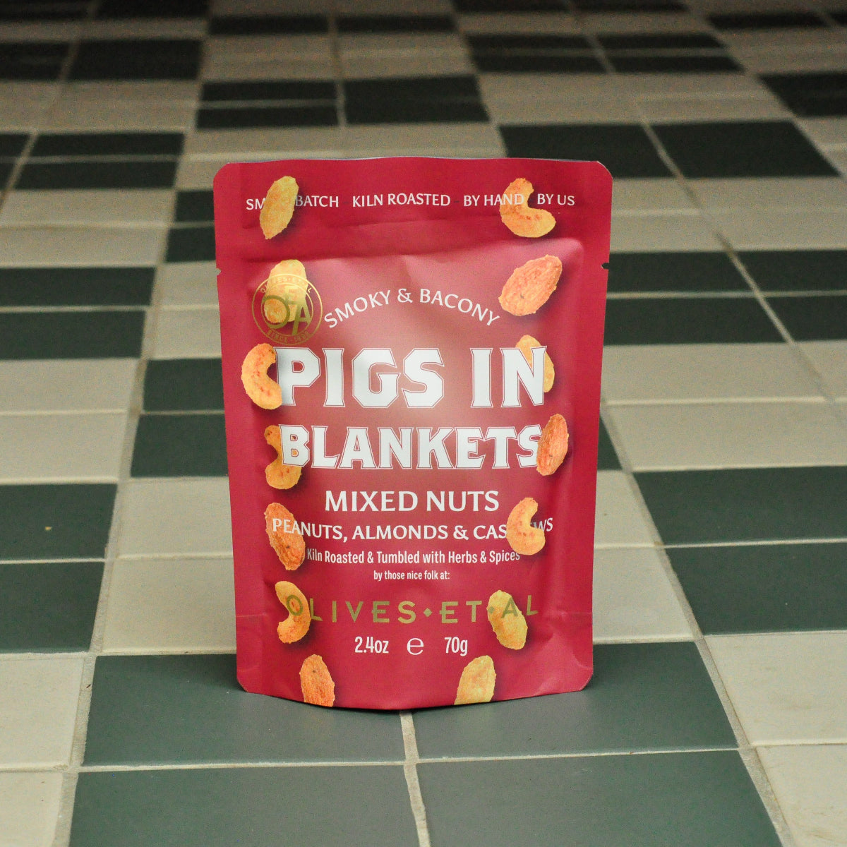 Packaged pigs in blankets nuts on a tiled floor