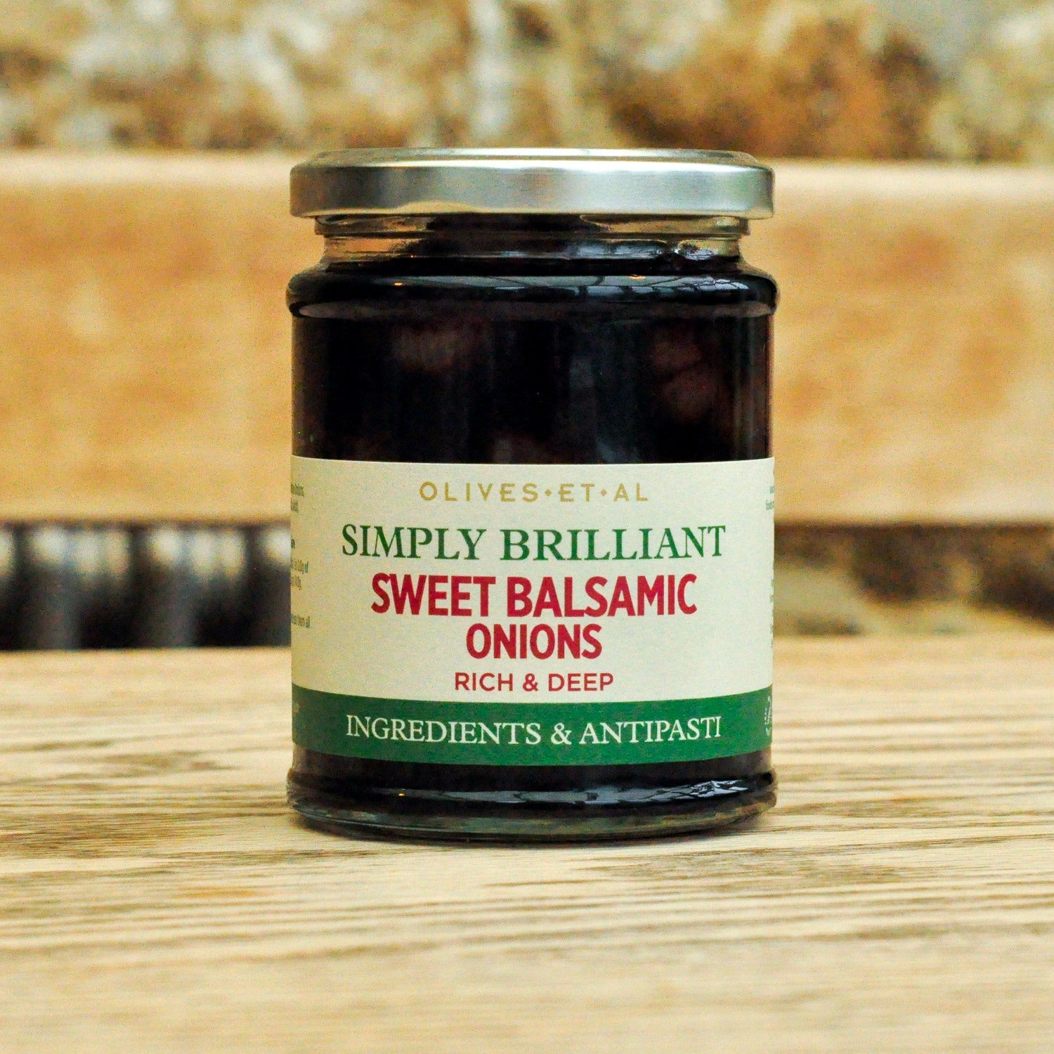 Jar of 'Simply Brilliant Sweet Balsamic Onions' on a wooden surface