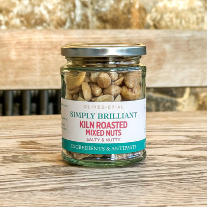 Jar of Olives Et Al kiln roasted mixed nuts with a label on a wooden surface