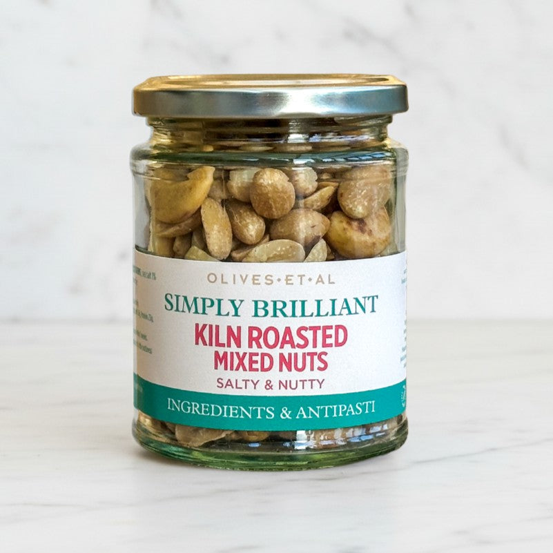 Jar of kiln roasted mixed nuts with a label on a white background