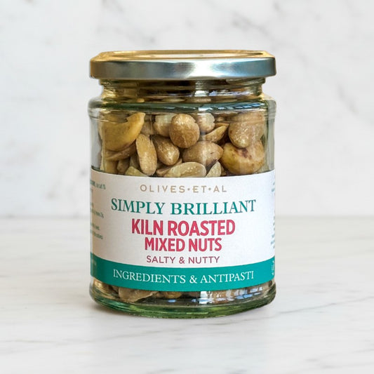 Jar of kiln roasted mixed nuts with a label on a white background