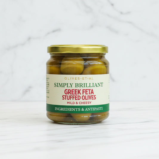 Jar of Greek Feta Stuffed Olives with a gold lid on a white background
