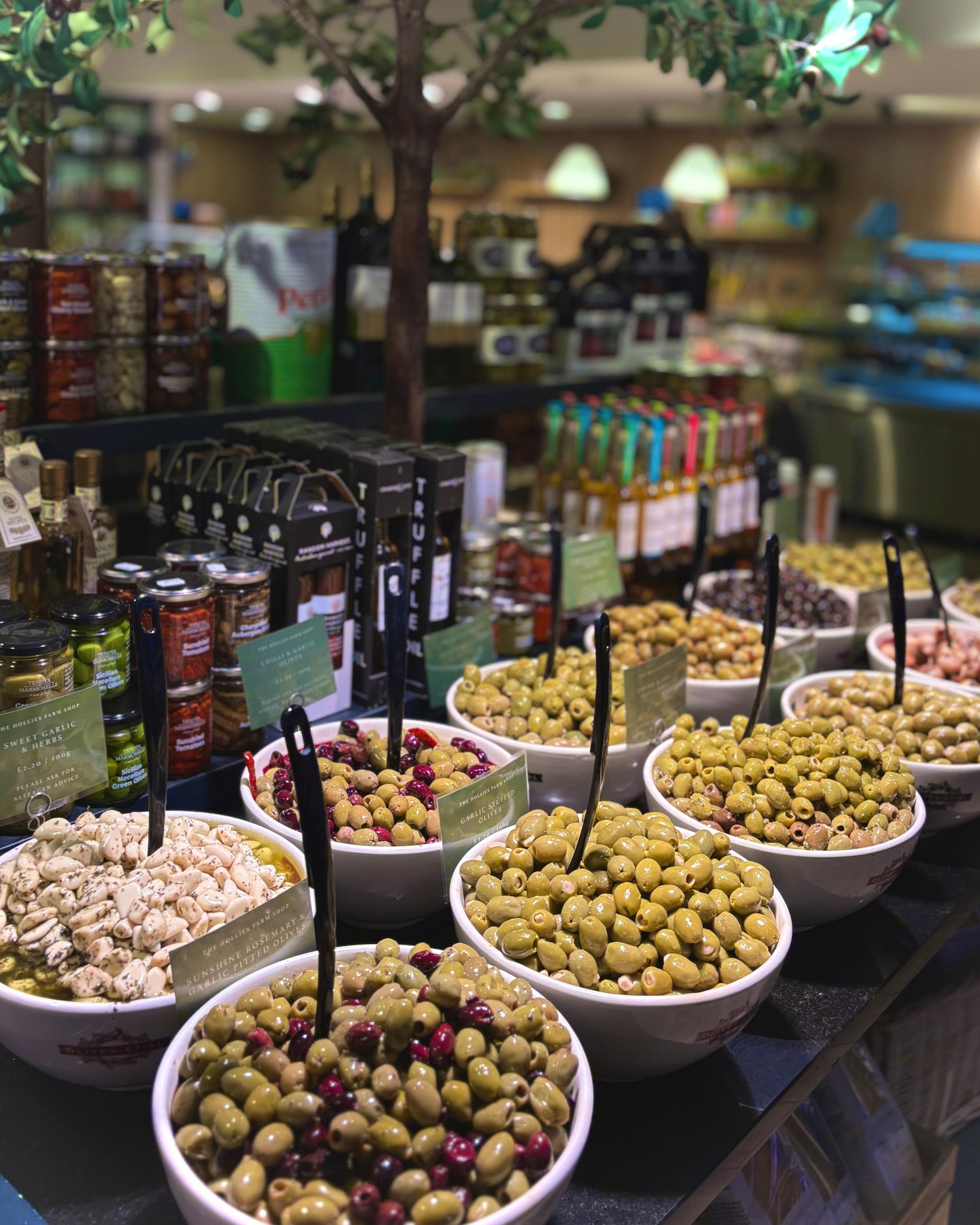 Display of bowls with olives and other snacks in a store setting