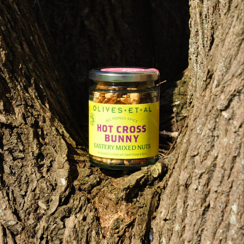 Jar of 'Hot Cross Bunny' mixed nuts in a tree cavity