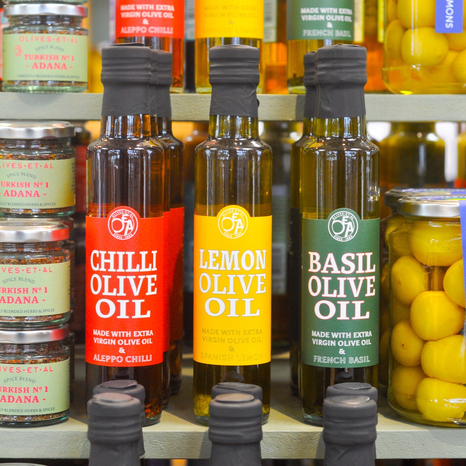 Bottles of infused Olive Oil on a farmshop shelf
