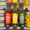 Bottles of infused Olive Oil on a farmshop shelf