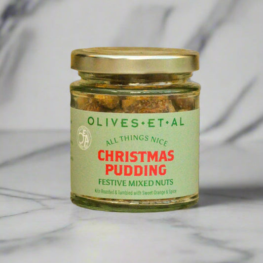 Jar of 'Christmas Pudding' festive mixed nuts on a wooden surface