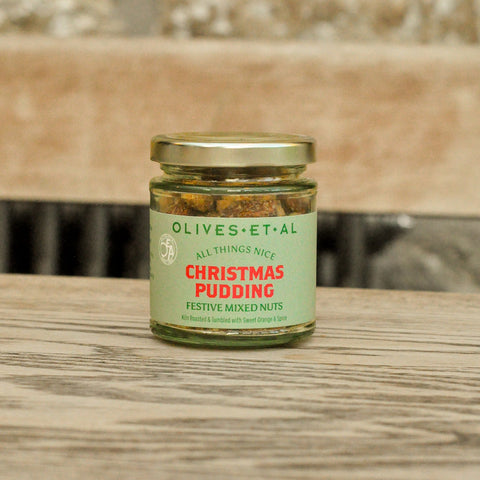 Jar of 'Christmas Pudding' festive mixed nuts on a wooden surface