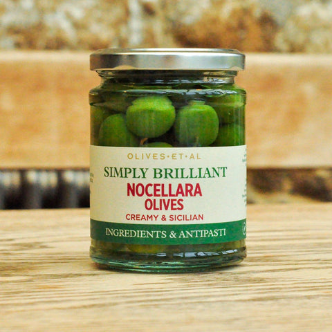 Jar of Nocellara Olives with a label on a wooden surface