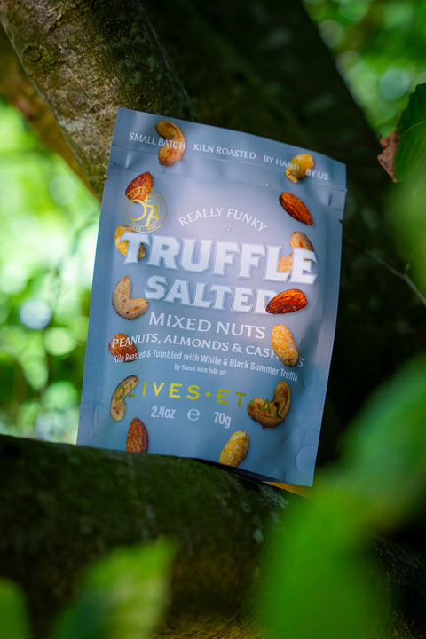 Packaged mixed nuts with truffle flavor hanging on a tree branch
