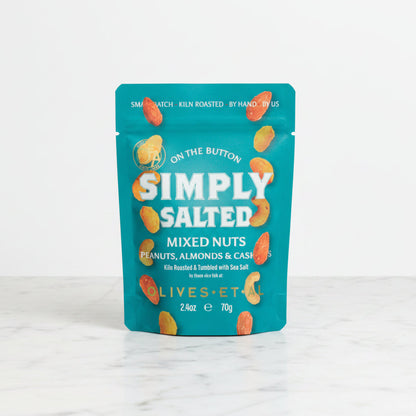Teal package of 'Simply Salted' mixed nuts on a tiled floor
