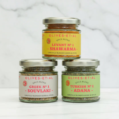 Olives Et Al Spice Blend trio on white marble background