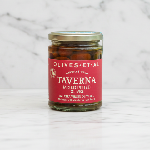 Jar of Taverna mixed pitted olives on a marble surface