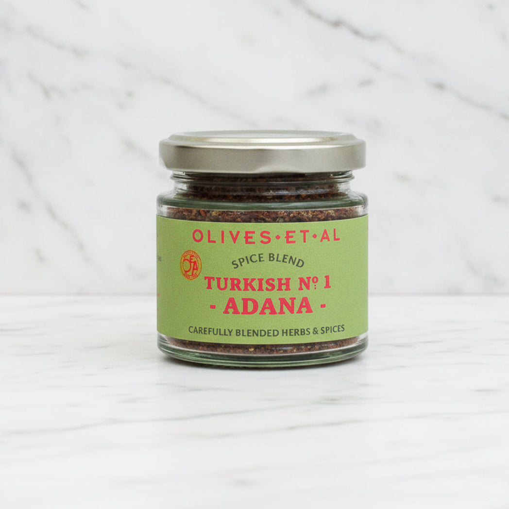 Jar of Olives Et Al Spice Blend on a marble background