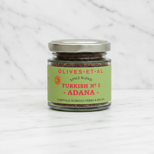 Jar of Olives Et Al Spice Blend on a marble background